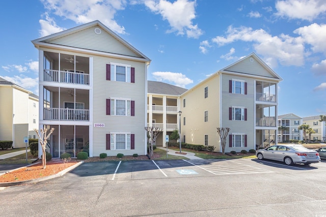 view of building exterior featuring uncovered parking