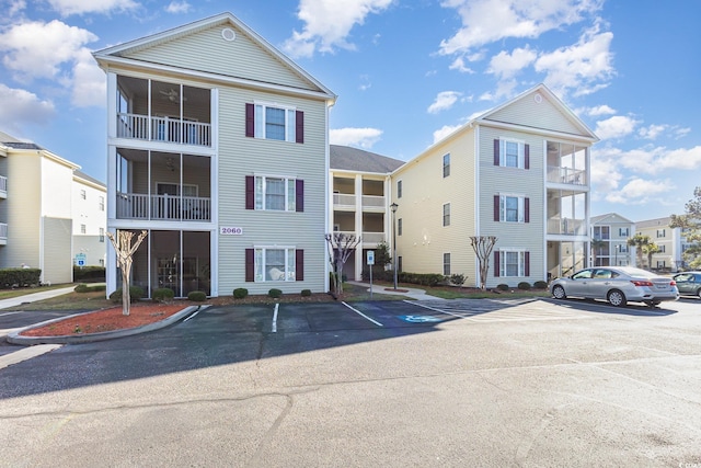 view of building exterior featuring uncovered parking