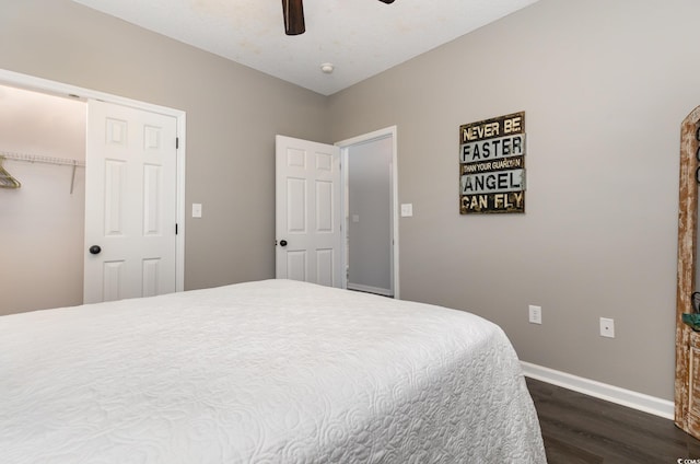 bedroom with ceiling fan, a closet, baseboards, and dark wood-style floors