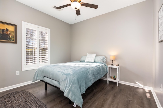 bedroom featuring a ceiling fan, wood finished floors, baseboards, and visible vents