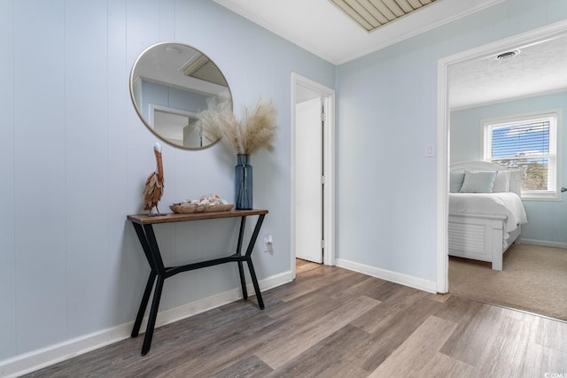 hall with baseboards and wood finished floors