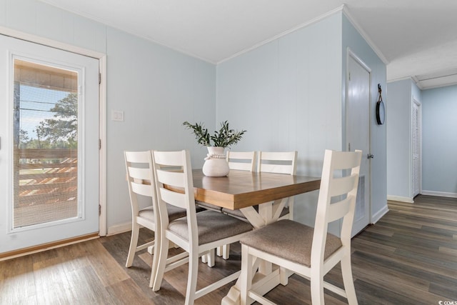 dining room featuring baseboards, dark wood-type flooring, and crown molding