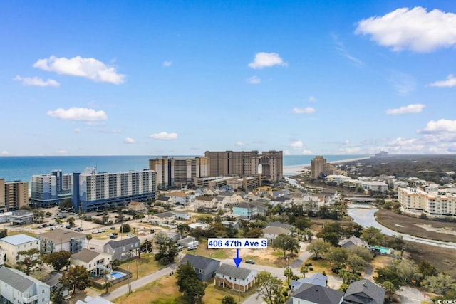 drone / aerial view featuring a view of city and a water view