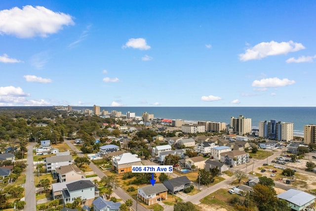 birds eye view of property with a view of city and a water view