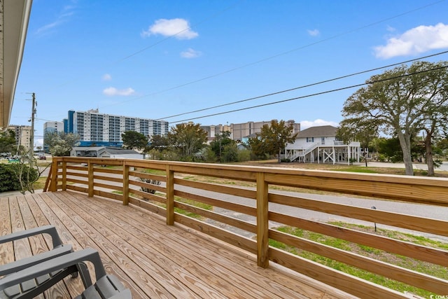 wooden deck with a view of city