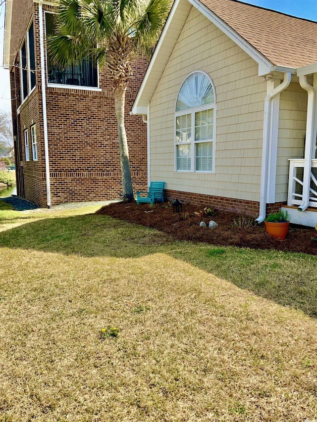 view of side of property with a lawn