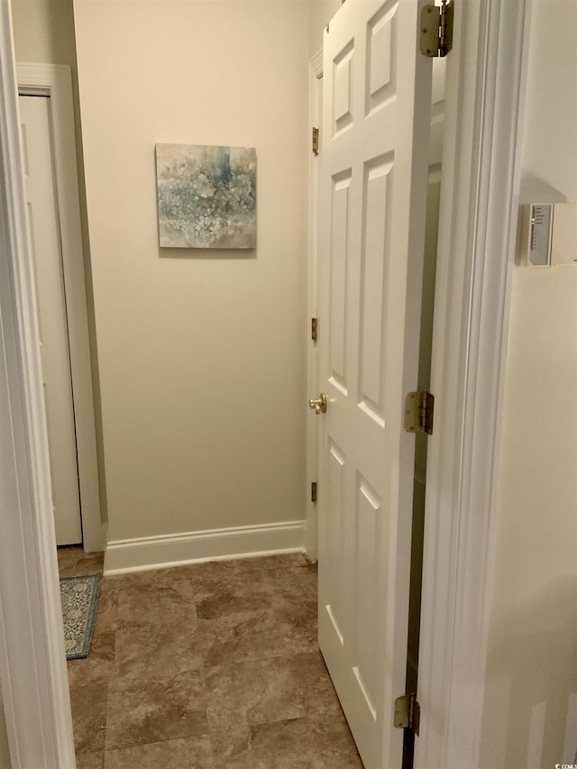 hall featuring baseboards