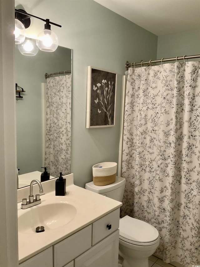 bathroom featuring curtained shower, toilet, and vanity