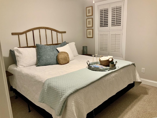 carpeted bedroom featuring baseboards