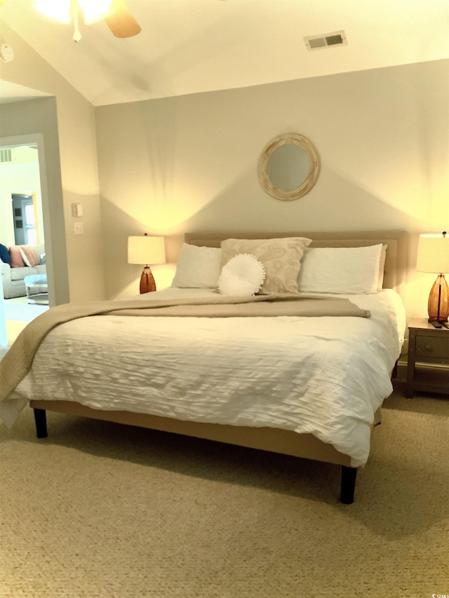 carpeted bedroom featuring lofted ceiling, visible vents, and ceiling fan