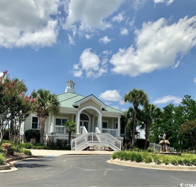 view of front of home featuring a porch, metal roof, and a standing seam roof