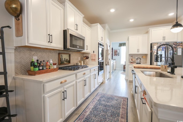 780 Old Murrells Inlet Rd, Murrells Inlet, SC 29576 - kitchen with stainless steel appliances, a sink, white cabinets, backsplash, and crown molding