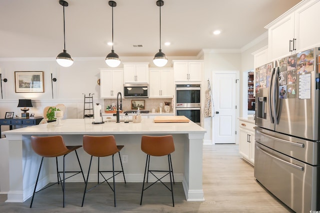 780 Old Murrells Inlet Rd, Murrells Inlet, SC 29576 - kitchen featuring appliances with stainless steel finishes, ornamental molding, decorative backsplash, white cabinets, and a breakfast bar