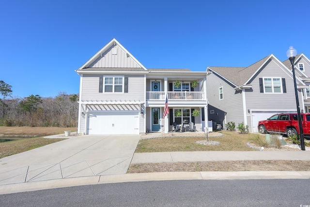 780 Old Murrells Inlet Rd, Murrells Inlet, SC 29576 - view of front of house with board and batten siding, a garage, driveway, a porch, and a balcony