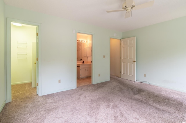 unfurnished bedroom with ensuite bath, carpet, and baseboards