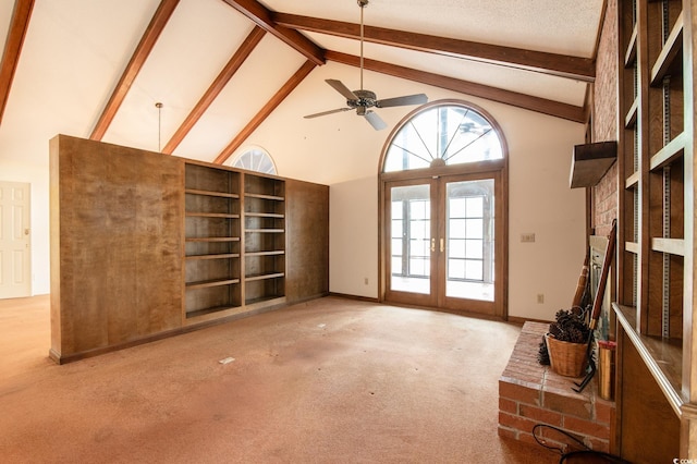 unfurnished living room featuring beam ceiling, french doors, high vaulted ceiling, and carpet floors