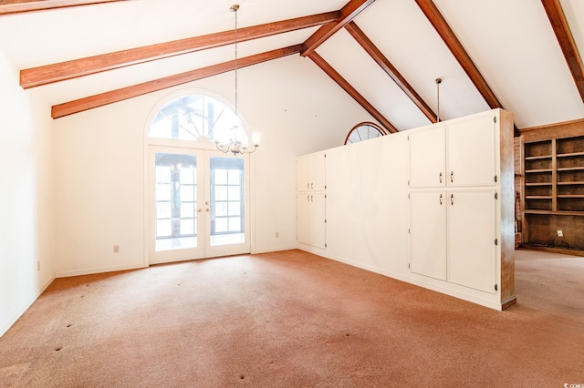 unfurnished living room with beamed ceiling, light colored carpet, a notable chandelier, and french doors