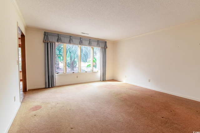 empty room with carpet flooring, visible vents, and ornamental molding