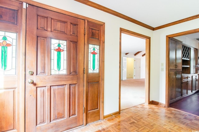 entrance foyer with crown molding and baseboards