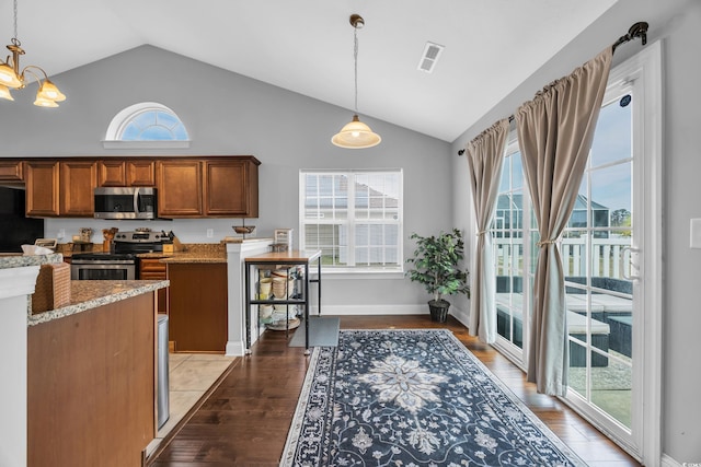 216 Camrose Way, Myrtle Beach, SC 29579 - kitchen with appliances with stainless steel finishes, light wood-style flooring, brown cabinets, decorative light fixtures, and high vaulted ceiling