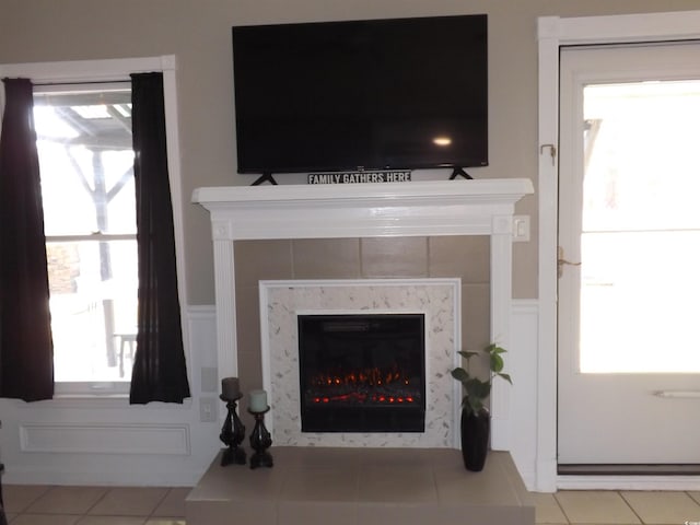 room details with a glass covered fireplace and wainscoting