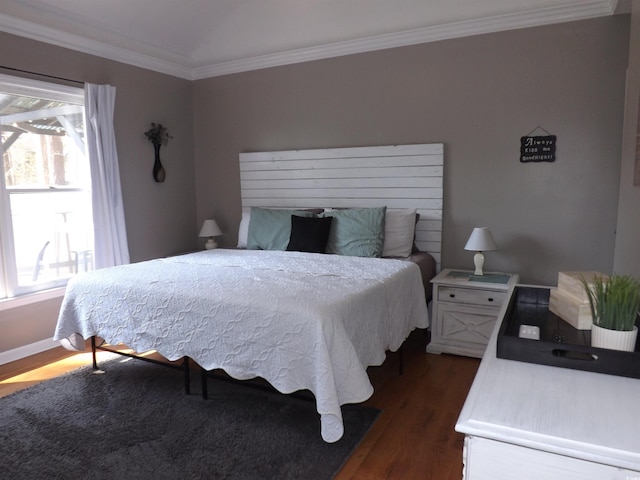 bedroom featuring crown molding, multiple windows, and wood finished floors