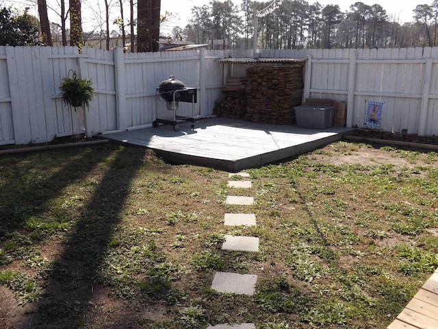 view of yard with a fenced backyard and a wooden deck