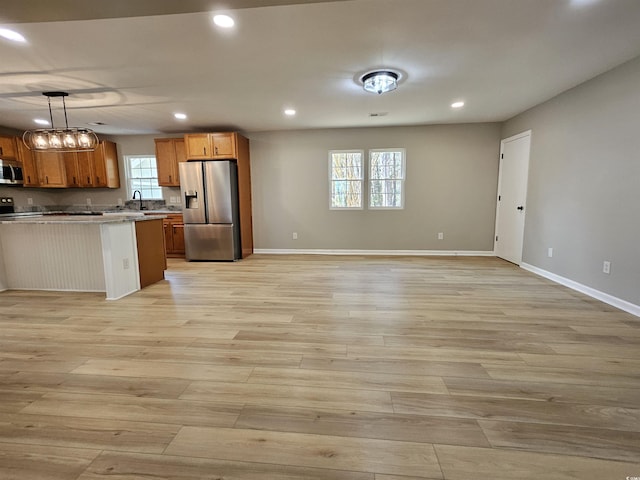 kitchen with recessed lighting, light wood-style flooring, stainless steel appliances, and baseboards