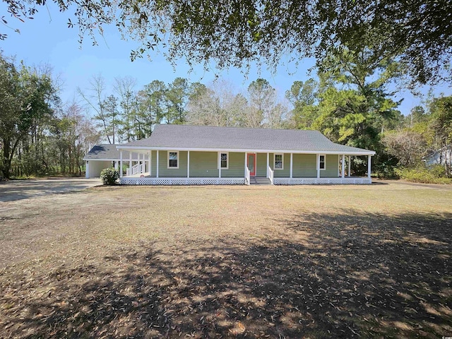 view of front facade featuring a carport, covered porch, and driveway