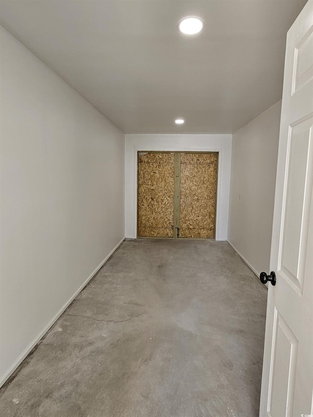 unfurnished room featuring recessed lighting and concrete flooring