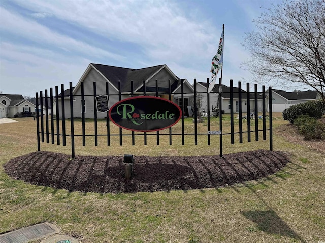 community / neighborhood sign featuring a yard