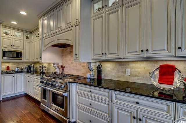 9785 Anchor Dr, Longs, SC 29568 - kitchen featuring stainless steel appliances, tasteful backsplash, dark wood-style floors, glass insert cabinets, and recessed lighting