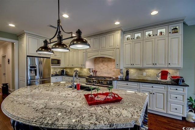 9785 Anchor Dr, Longs, SC 29568 - kitchen featuring appliances with stainless steel finishes, dark wood-style floors, dark stone counters, tasteful backsplash, and recessed lighting