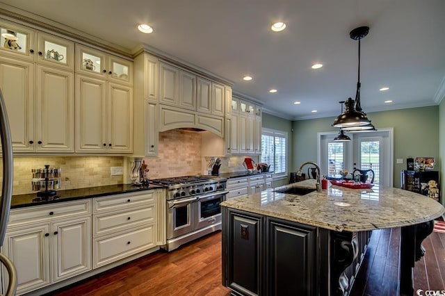 9785 Anchor Dr, Longs, SC 29568 - kitchen featuring range with two ovens, a sink, cream cabinets, dark wood-style floors, and tasteful backsplash