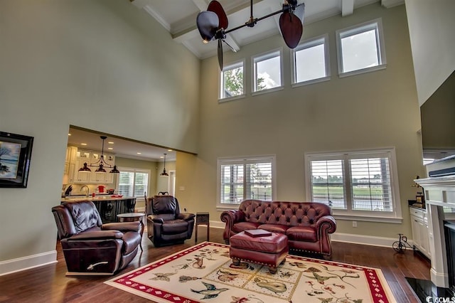 9785 Anchor Dr, Longs, SC 29568 - living area with a high ceiling, dark wood finished floors, beam ceiling, baseboards, and a fireplace with flush hearth