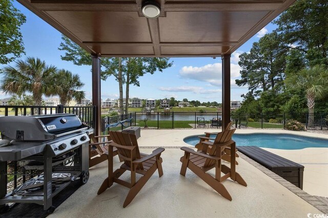 9785 Anchor Dr, Longs, SC 29568 - fenced backyard featuring a water view, a patio area, and a grill