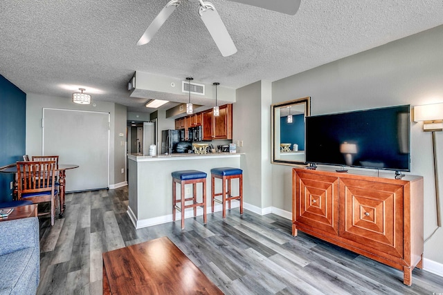 5300 N Ocean Blvd Unit 1003, Myrtle Beach, SC 29577 - kitchen with visible vents, dark wood-type flooring, ceiling fan, a peninsula, and black appliances