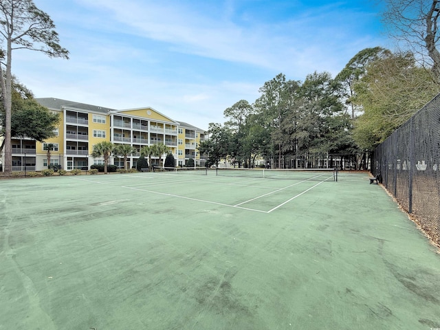 view of tennis court with fence