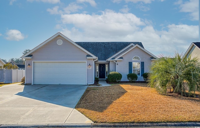 single story home with concrete driveway, an attached garage, and fence