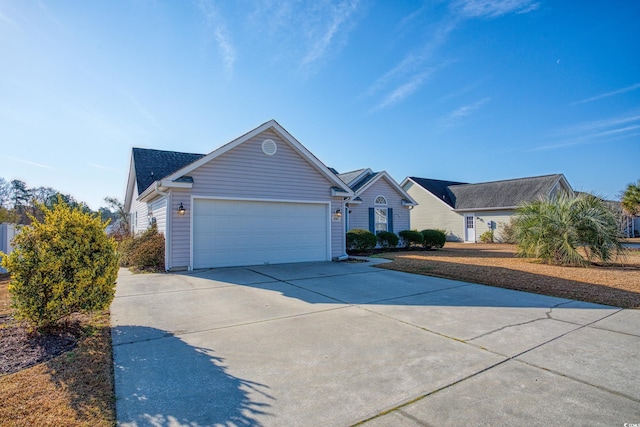 single story home featuring an attached garage and driveway