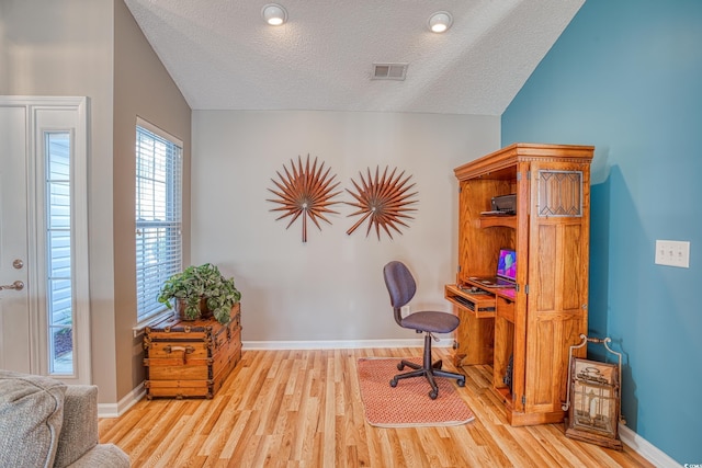 office featuring visible vents, a textured ceiling, baseboards, and wood finished floors