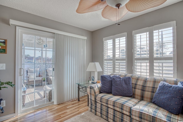 living area featuring a textured ceiling and wood finished floors