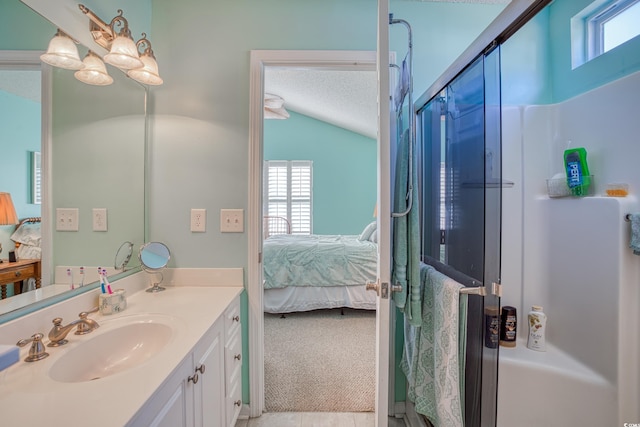 full bathroom with a wealth of natural light, a textured ceiling, and ensuite bathroom