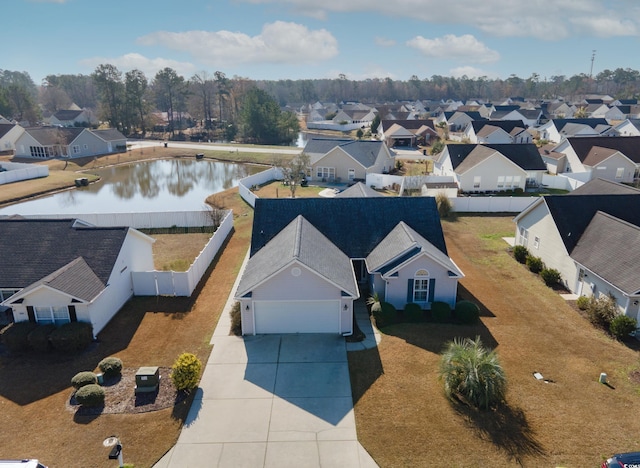 drone / aerial view featuring a residential view and a water view