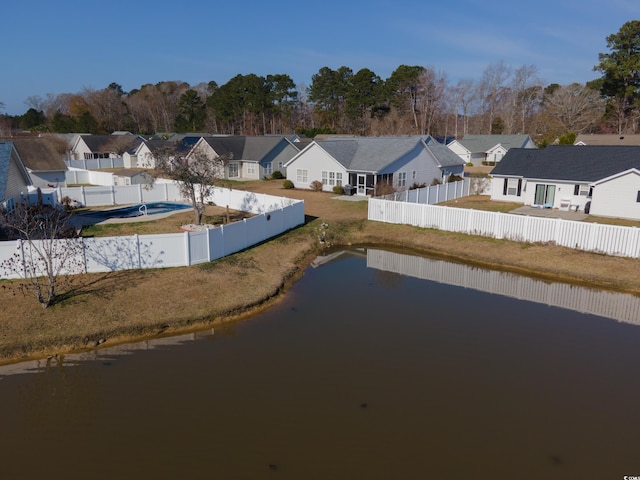 drone / aerial view featuring a residential view and a water view