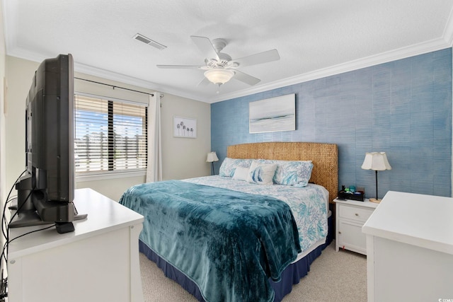 bedroom featuring a ceiling fan, visible vents, a textured ceiling, crown molding, and light carpet