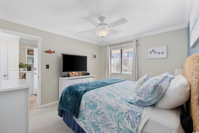 bedroom featuring light carpet, a textured ceiling, baseboards, and ornamental molding