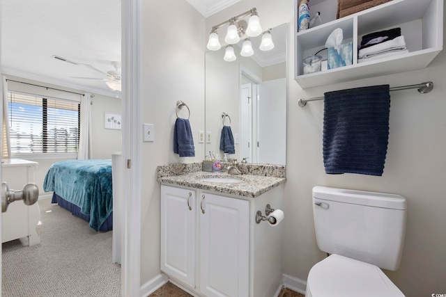 bathroom with crown molding, ceiling fan, toilet, ensuite bathroom, and vanity