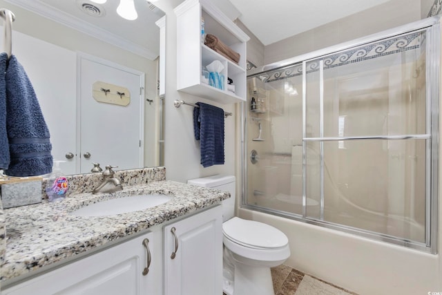 full bathroom featuring visible vents, toilet, combined bath / shower with glass door, crown molding, and vanity