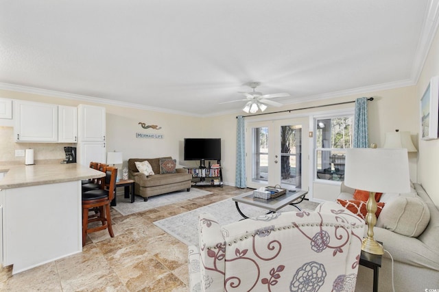 living room featuring a ceiling fan and crown molding